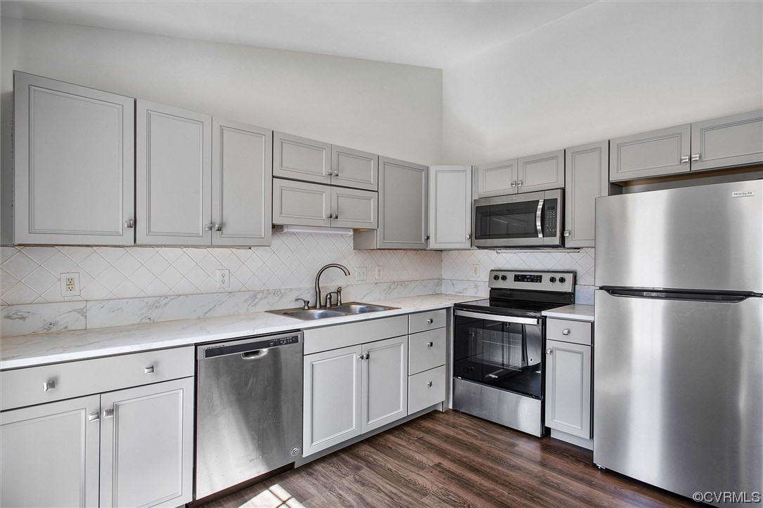 8911 Midway Road Henrico, VA 23229 - Photo 10 of 30 a kitchen with a sink a refrigerator a microwave and cabinets