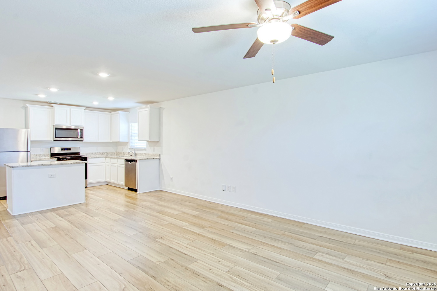 10939 Delight Grove Converse, TX 78109 - Photo 3 of 12 a view of kitchen with wooden floor and window