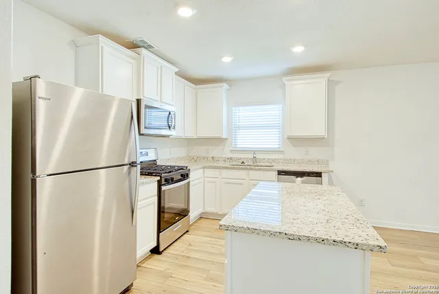a white refrigerator freezer sitting inside of a kitchen