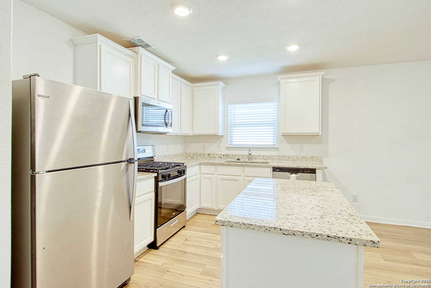 10939 Delight Grove Converse, TX 78109 - Photo 6 of 12 a white refrigerator freezer sitting inside of a kitchen
