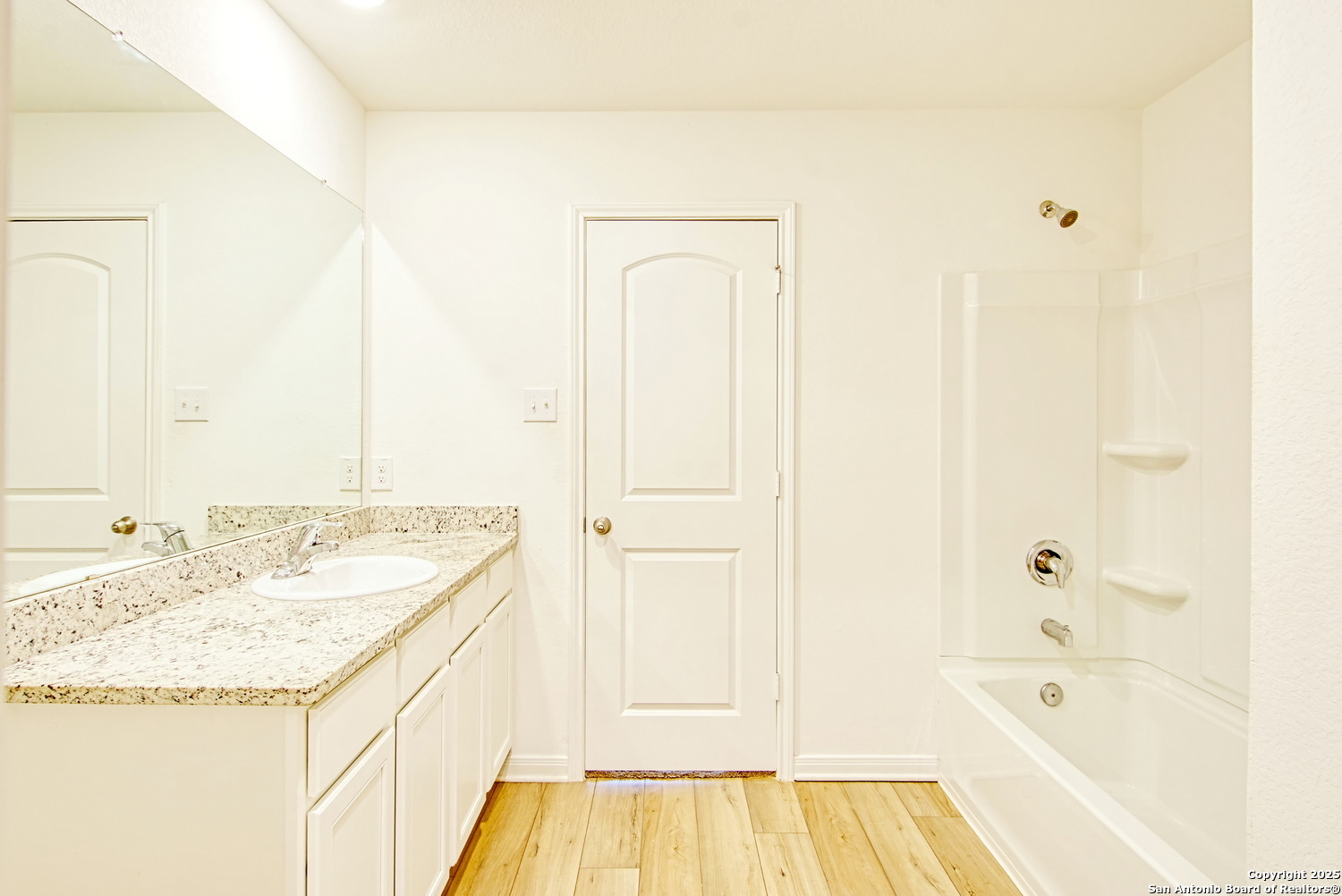 10939 Delight Grove Converse, TX 78109 - Photo 8 of 12 a bathroom with a granite countertop sink and a bathtub