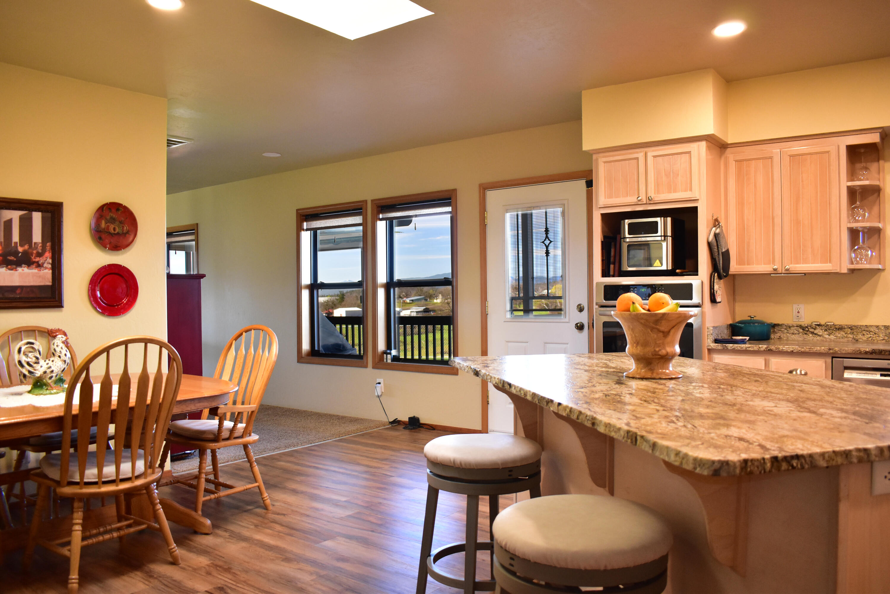 865 Reese Creek Road Eagle Point, OR 97524 - Photo 17 of 37 a kitchen with stainless steel appliances granite countertop a table and chairs