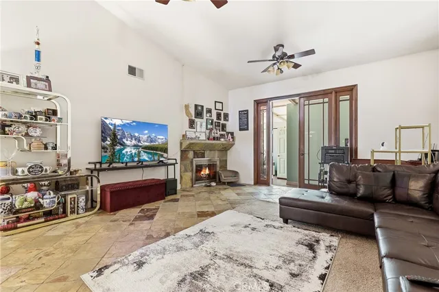 a living room with furniture a flat screen tv and a fireplace