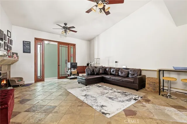 a living room with furniture ceiling fan and a wooden floor