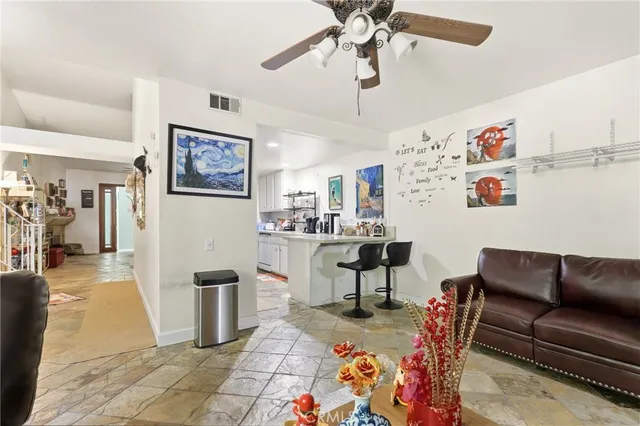 a living room with furniture and painting on the wall