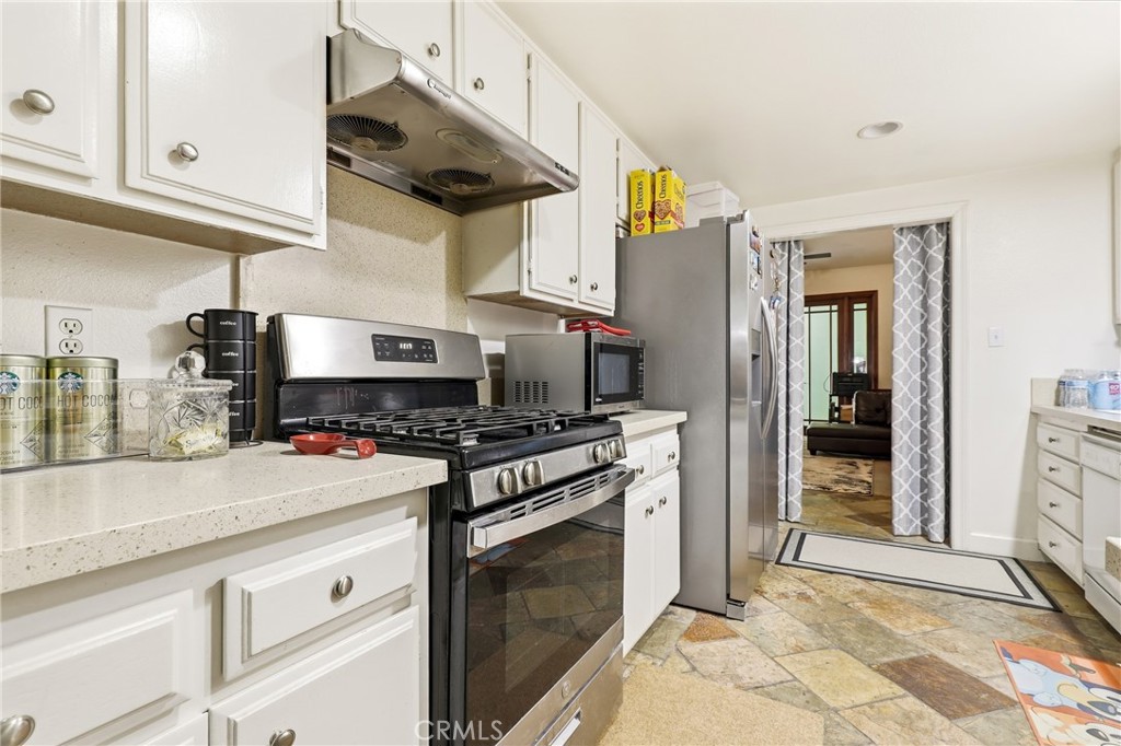 3575 Falconridge Road Yorba Linda, CA 92886 - Photo 9 of 21 a kitchen with stainless steel appliances granite countertop a stove and a sink
