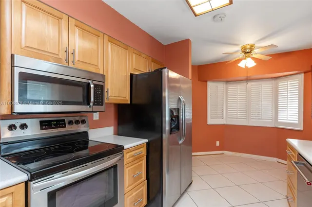 a kitchen with stainless steel appliances a stove microwave and refrigerator