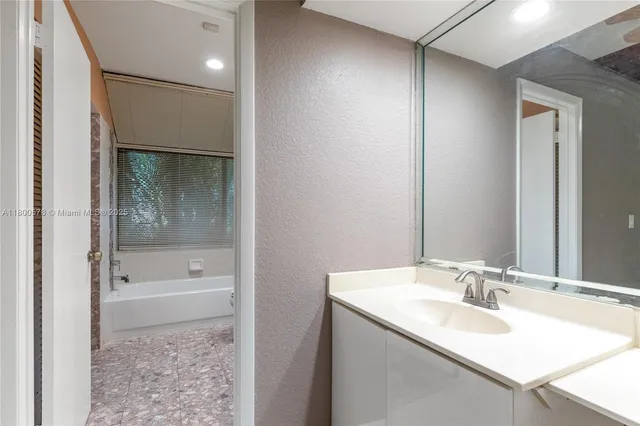 a bathroom with a shower a bathtub and a toilet