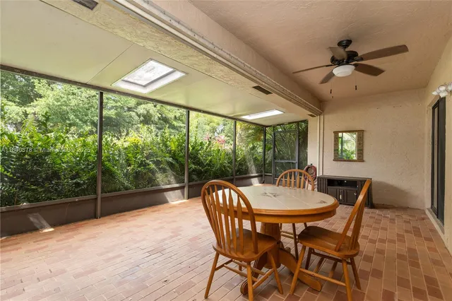 a view of a lake with a yard and large trees