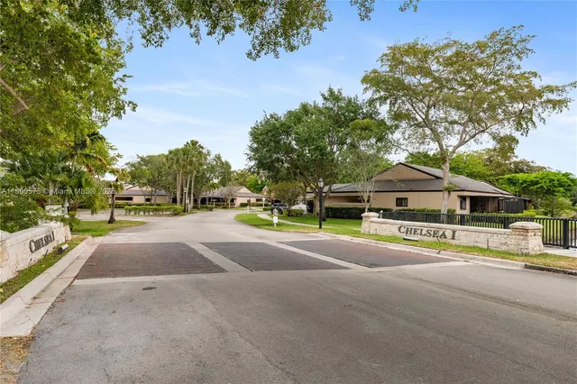 an aerial view of a house with a yard and lake view