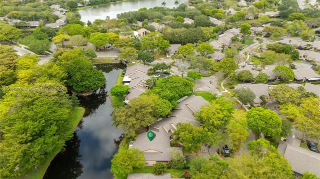 an aerial view of a house with a yard and lake view