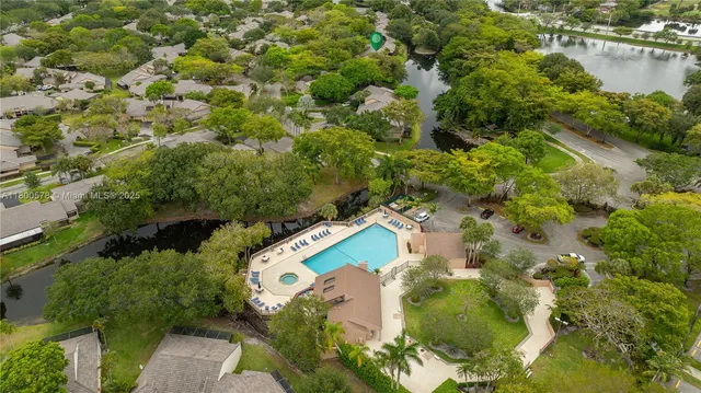 an aerial view of a house with a yard and lake view