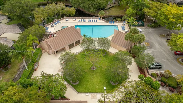 an aerial view of a house with a yard and lake view