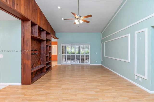 a view of an empty room with a window and closet