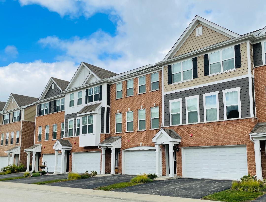 a front view of a residential apartment building with a yard