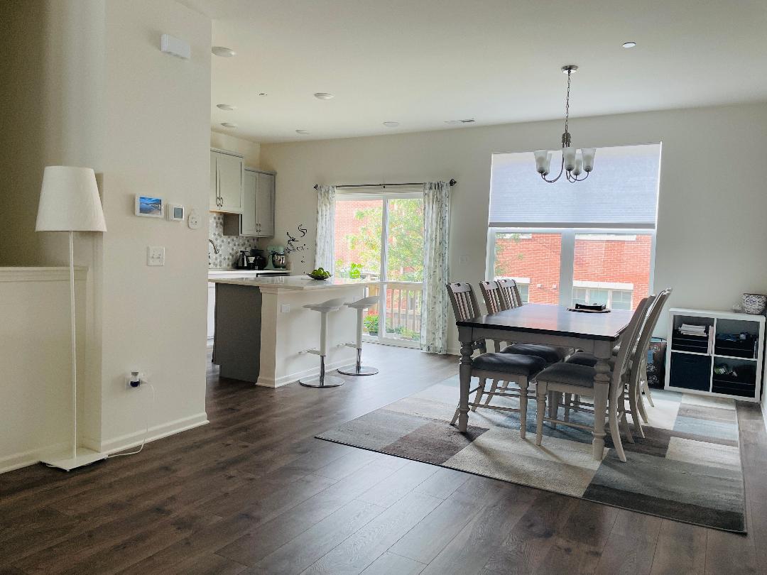 48 Grey Wolf Drive Wheeling, IL 60090 - Photo 11 of 23 a view of a dining room with furniture window and wooden floor