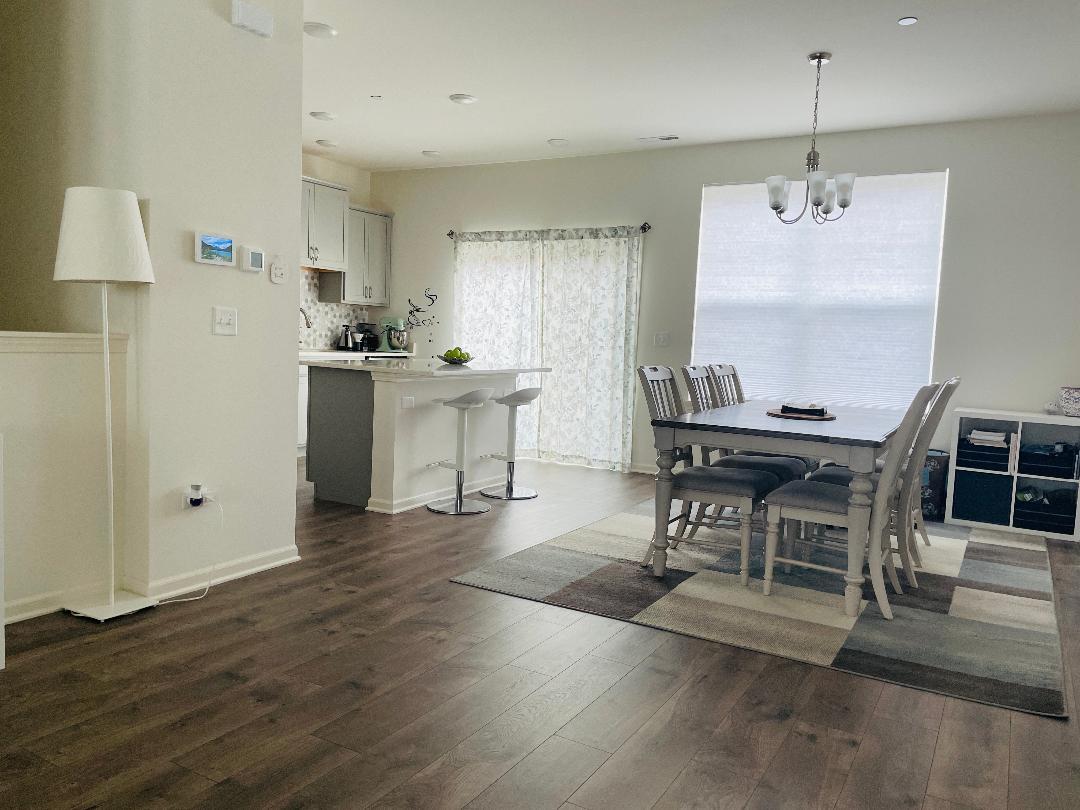 48 Grey Wolf Drive Wheeling, IL 60090 - Photo 12 of 23 a living room with furniture a dining table and a refrigerator