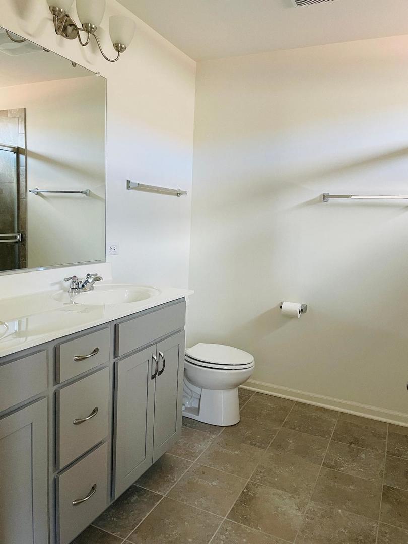 48 Grey Wolf Drive Wheeling, IL 60090 - Photo 17 of 23 a spacious bathroom with a toilet sink and mirror