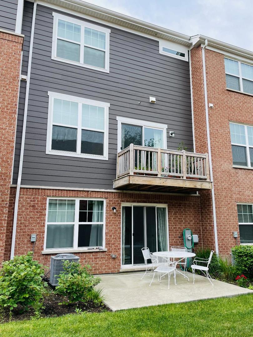 48 Grey Wolf Drive Wheeling, IL 60090 - Photo 3 of 23 a view of a building with a yard