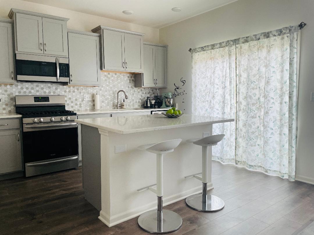 48 Grey Wolf Drive Wheeling, IL 60090 - Photo 9 of 23 a kitchen with stainless steel appliances a white cabinets and a stove top oven