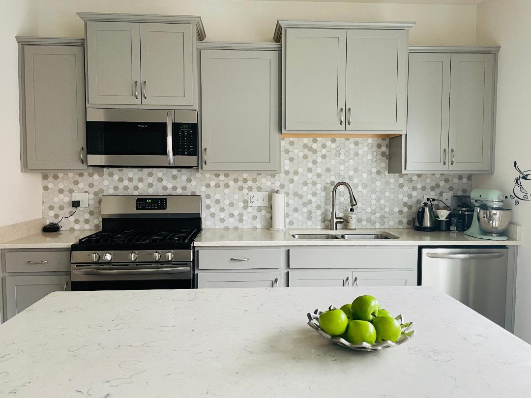 48 Grey Wolf Drive Wheeling, IL 60090 - Photo 10 of 23 a kitchen with stainless steel appliances a sink a stove cabinets and a microwave
