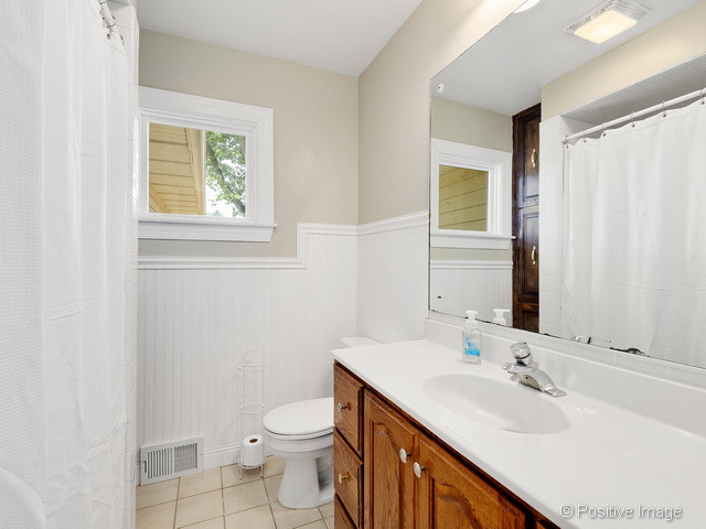 908 Ranch Road Wheaton, IL 60187 - Photo 13 of 25 a bathroom with a sink a toilet and a mirror
