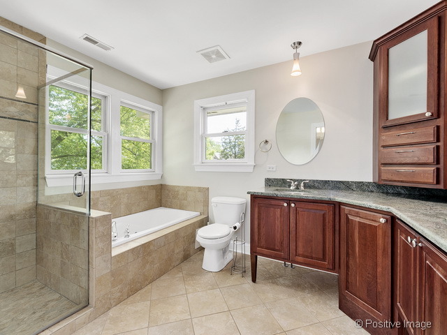 908 Ranch Road Wheaton, IL 60187 - Photo 16 of 25 a bath room with a toilet a sink and a large window