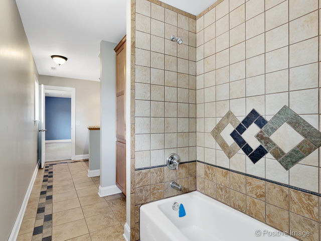 908 Ranch Road Wheaton, IL 60187 - Photo 18 of 25 a bathroom with a bathtub and shower