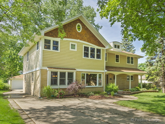 908 Ranch Road Wheaton, IL 60187 - Photo 2 of 25 a front view of a house with a yard