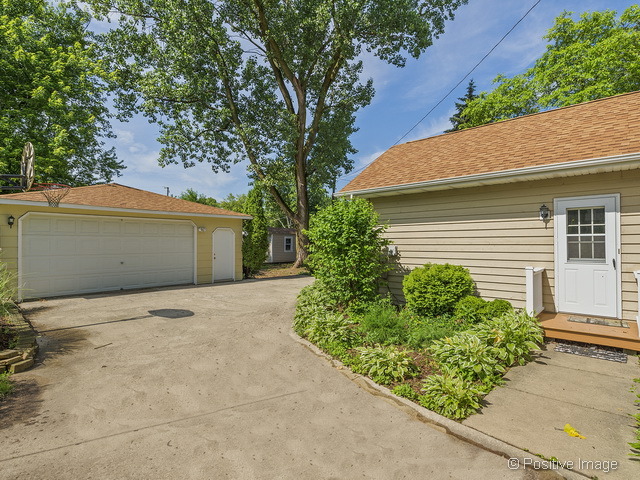 908 Ranch Road Wheaton, IL 60187 - Photo 23 of 25 a front view of a house with garden