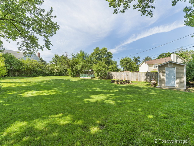 908 Ranch Road Wheaton, IL 60187 - Photo 25 of 25 a view of a white house with a big yard and potted plants