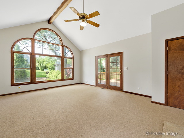 908 Ranch Road Wheaton, IL 60187 - Photo 10 of 25 an empty room with windows and a chandelier fan