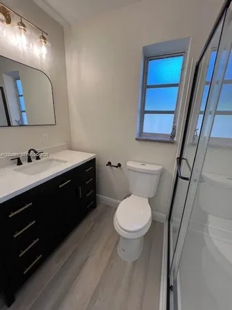 a bathroom with a sink toilet and mirror