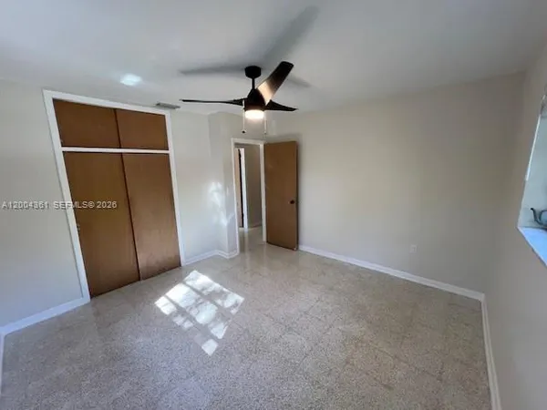 a view of a livingroom with a ceiling fan and window