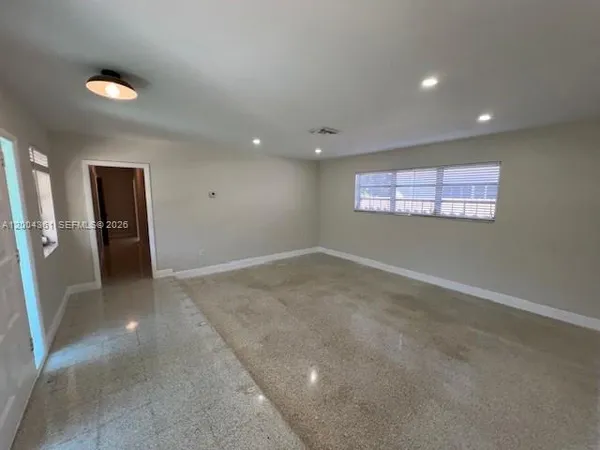 an empty room with windows and closet