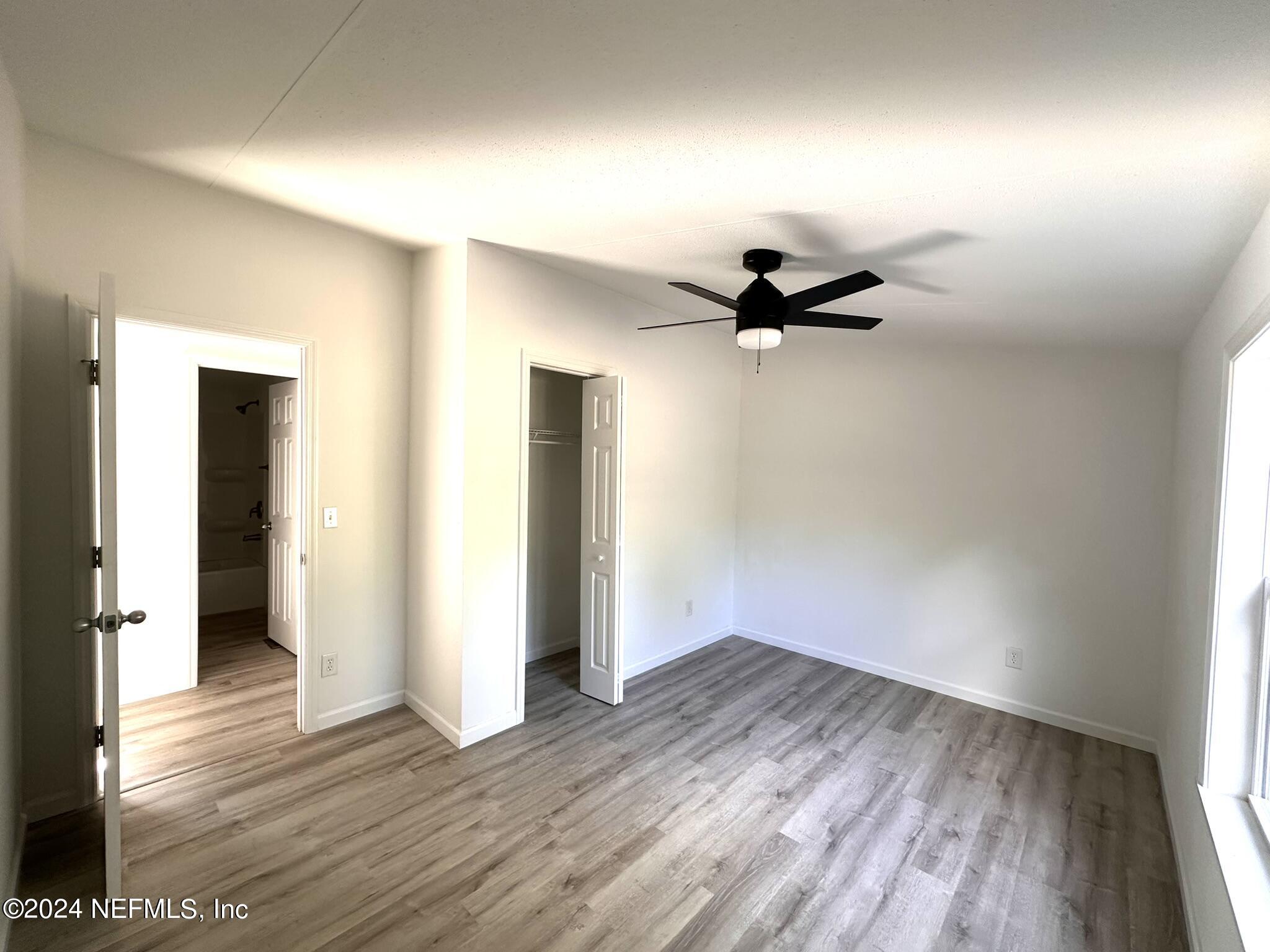 96757 Blackrock Road Yulee, FL 32097 - Photo 13 of 21 a view of empty room with wooden floor