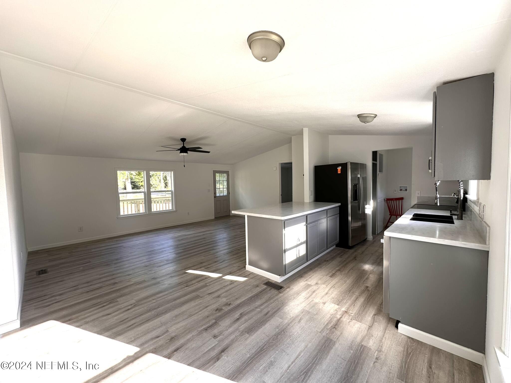 96757 Blackrock Road Yulee, FL 32097 - Photo 2 of 21 a kitchen with granite countertop a stove and a refrigerator