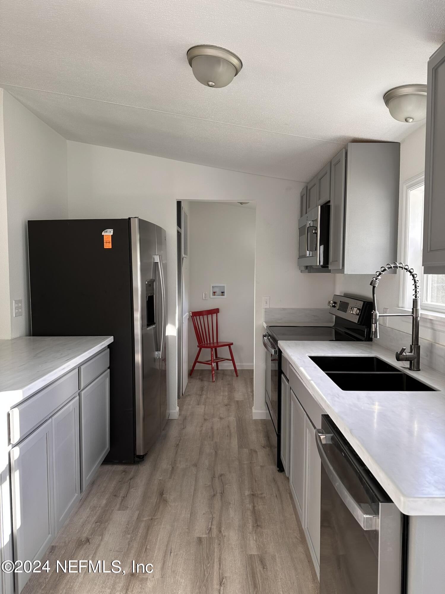 96757 Blackrock Road Yulee, FL 32097 - Photo 5 of 21 a kitchen with a sink stove and refrigerator