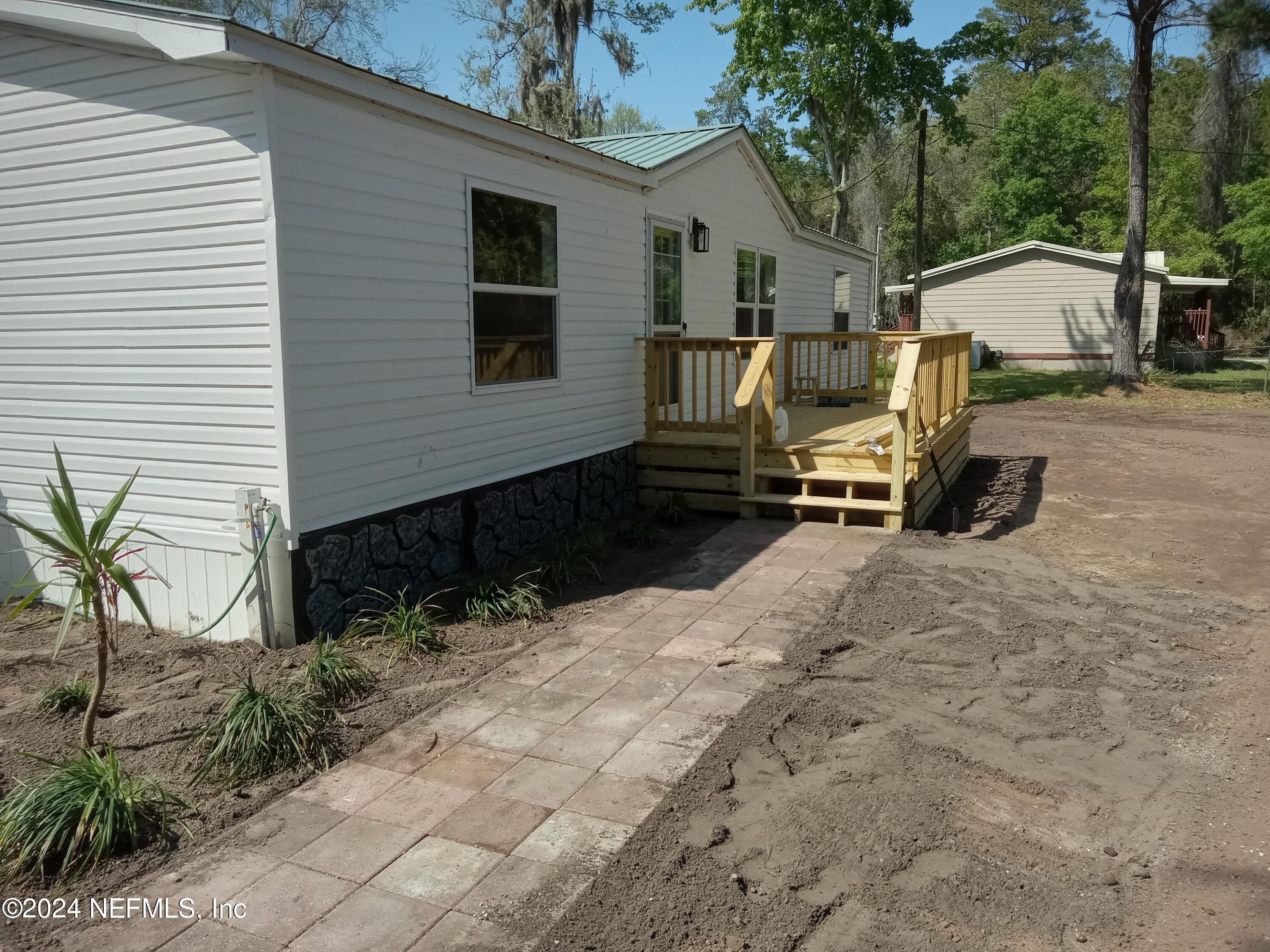 96757 Blackrock Road Yulee, FL 32097 - Photo 7 of 21 a view of backyard with a car parked in it