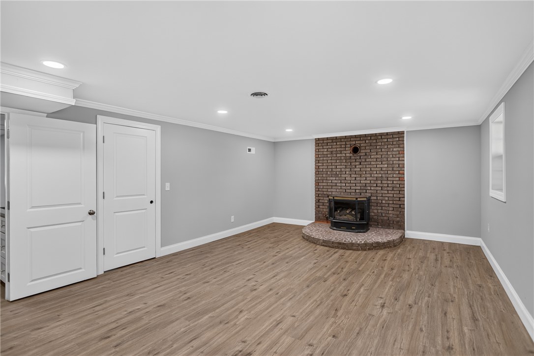 712 Beech Drive Seneca, SC 29678 - Photo 30 of 41 Cozy living area featuring durable laminate flooring and a charming brick fireplace.