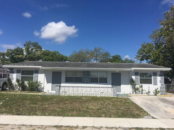 a front view of house with yard outdoor seating and green space