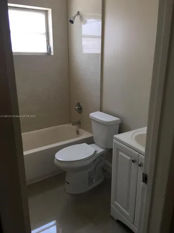 a white toilet sitting next to a bath tub