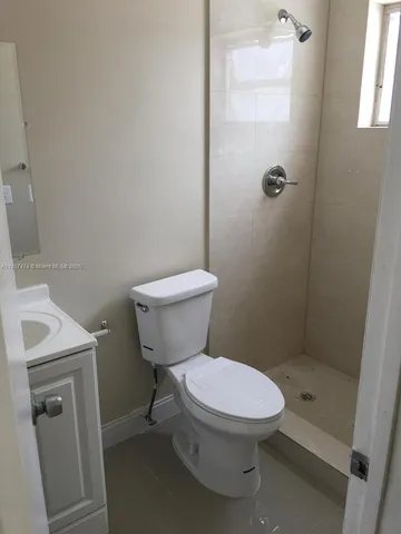 a white toilet sitting next to a bathroom sink