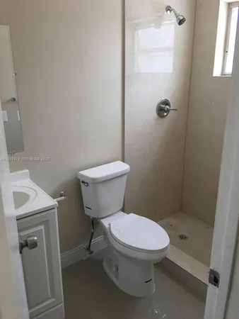 a white toilet sitting next to a bathroom sink