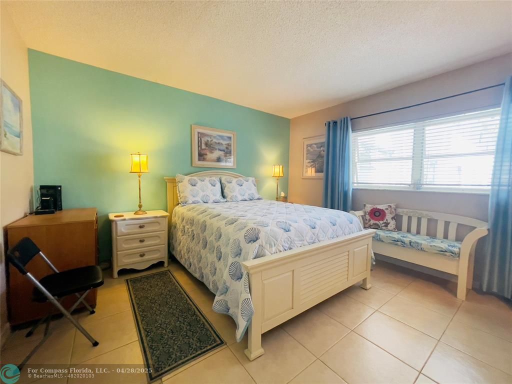 651 Pine Drive, Unit 207 Pompano Beach, FL 33060 - Photo 11 of 18 a bedroom with a bed and a couch