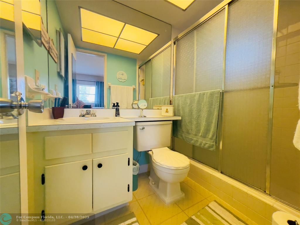 651 Pine Drive, Unit 207 Pompano Beach, FL 33060 - Photo 13 of 18 a bathroom with a sink mirror toilet and next to a window