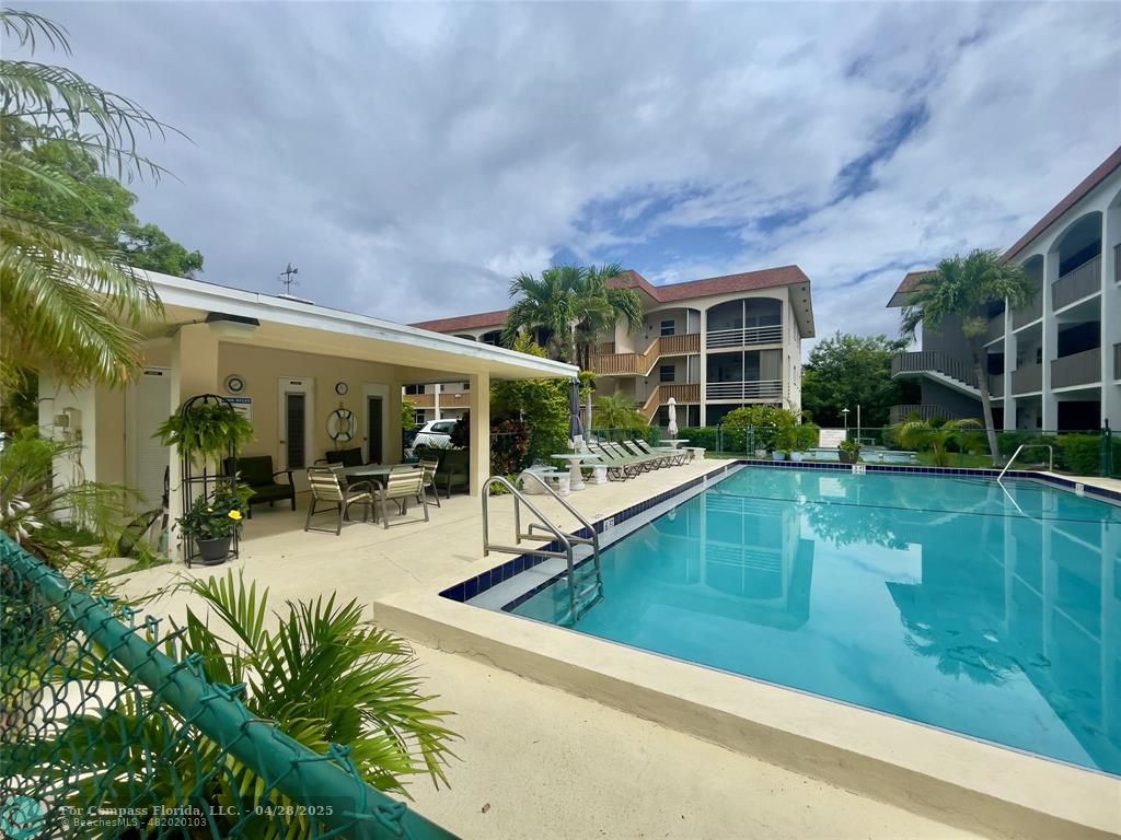 651 Pine Drive, Unit 207 Pompano Beach, FL 33060 - Photo 3 of 18 a view of a house with backyard porch and sitting area