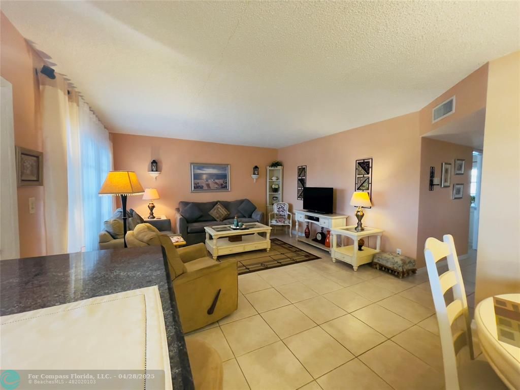 651 Pine Drive, Unit 207 Pompano Beach, FL 33060 - Photo 7 of 18 a living room with furniture and a fireplace