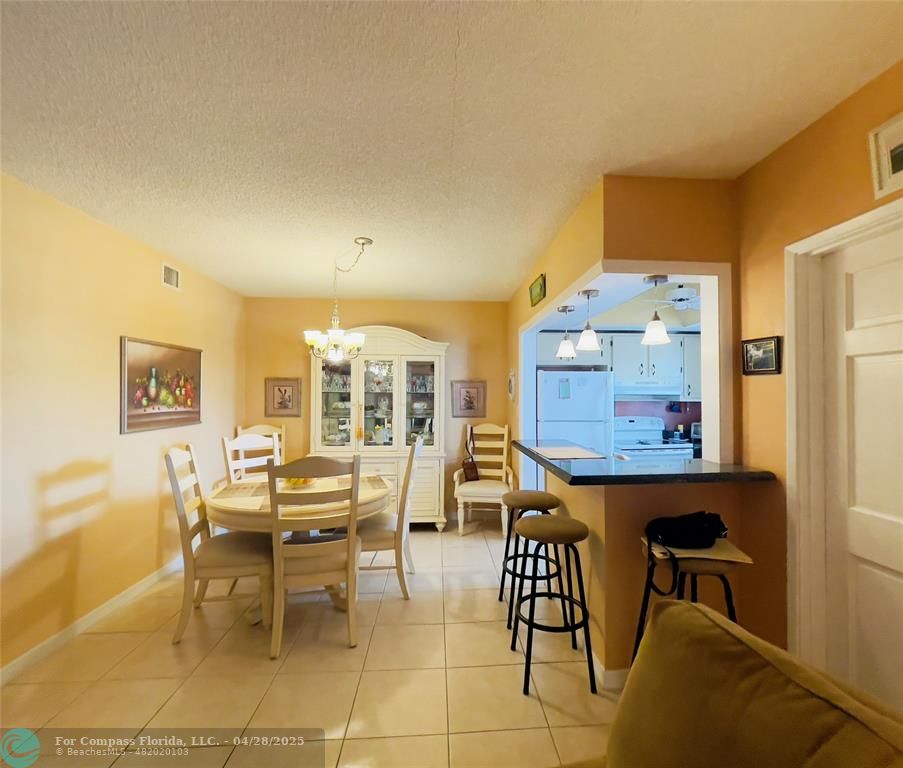 651 Pine Drive, Unit 207 Pompano Beach, FL 33060 - Photo 10 of 18 a view of a dining room with furniture