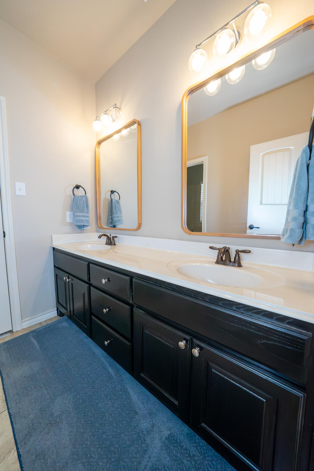 3301 County Road 7560 Lubbock, TX 79423 - Photo 29 of 40 a bathroom with a double vanity sink and a mirror